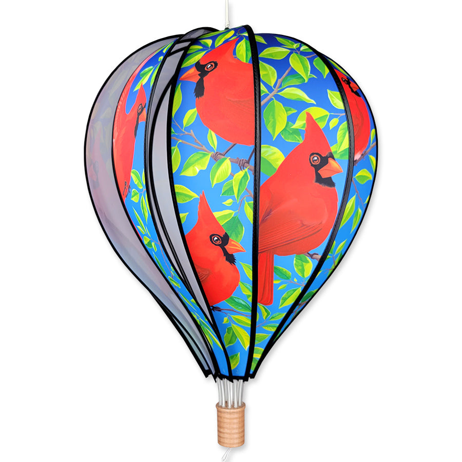22 in. Hot Air Balloon featuring vibrant cardinal design displayed in a colorful garden setting with flowers in the background.