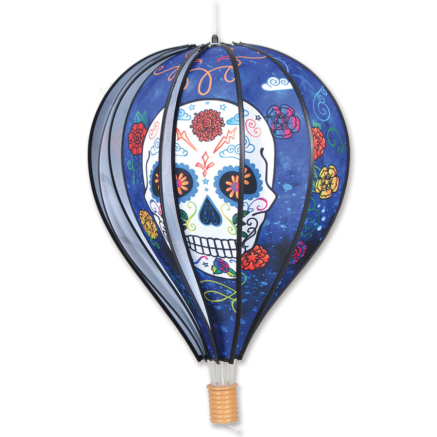 22 in. Hot Air Balloon - Day of the Dead Blue design, spinning gently in the garden setting, showcasing vibrant colors and cultural patterns.