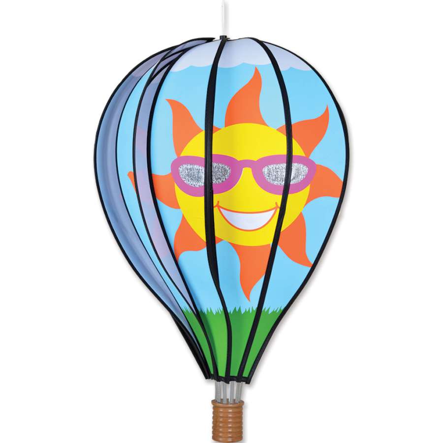22 in. Hot Air Balloon - Sun decoration spinning in an outdoor garden, showcasing its bright sun design and colorful fabric.