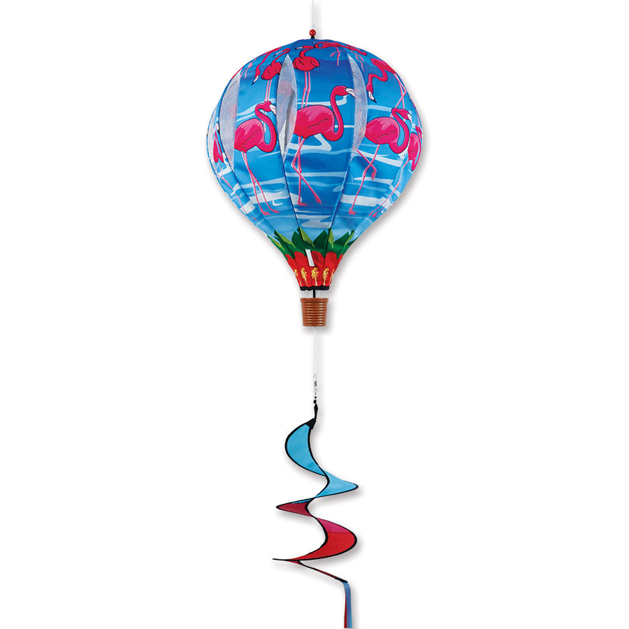 22 in. Pop-Open Hot Air Balloon with beach flamingo design, brightly displayed on a deck with greenery in the background.