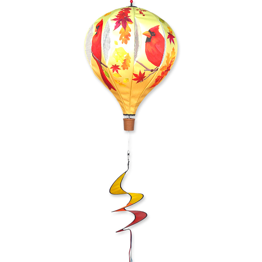 22 in. Pop-Open Hot Air Balloon in Fall Cardinal colors spinning gracefully on a porch, showcasing its vibrant and whimsical design.