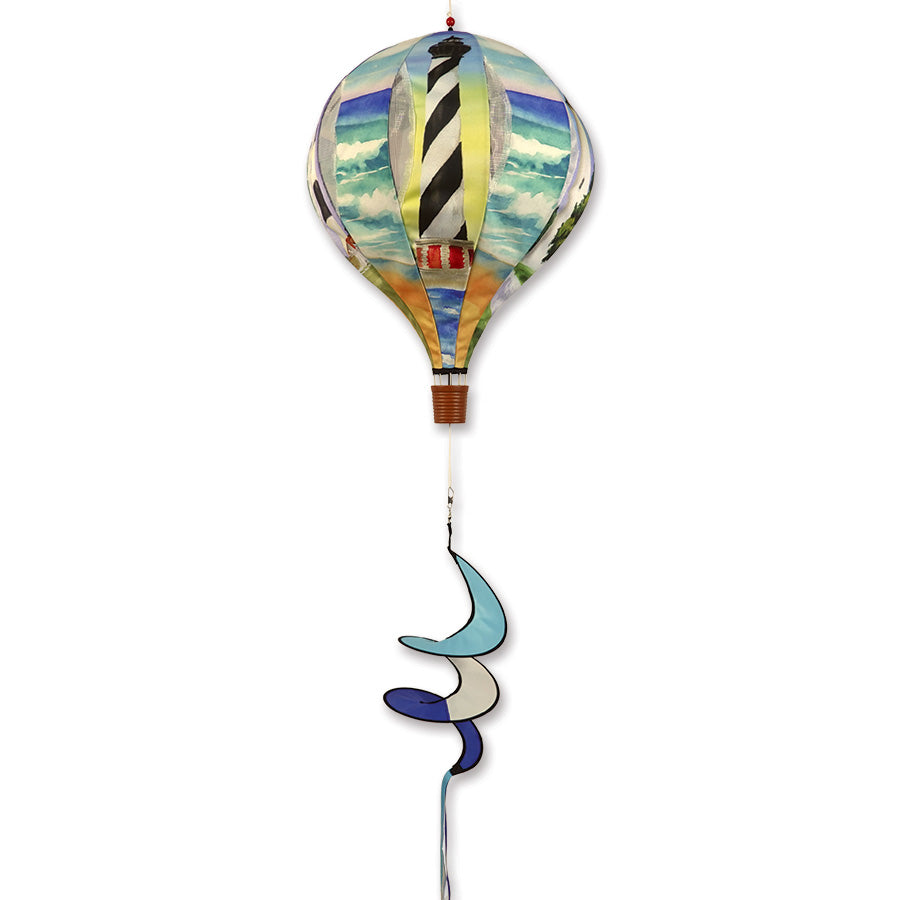 22 in. Pop-Open Hot Air Balloon featuring a light house design, effortlessly spinning in the wind on a sunny porch setting.