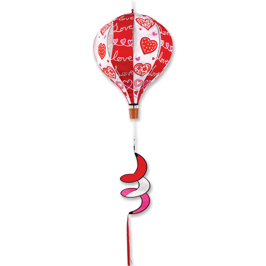 22 in. Pop-Open Hot Air Balloon wind spinner displayed on a porch, showcasing vibrant colors and easy assembly features.