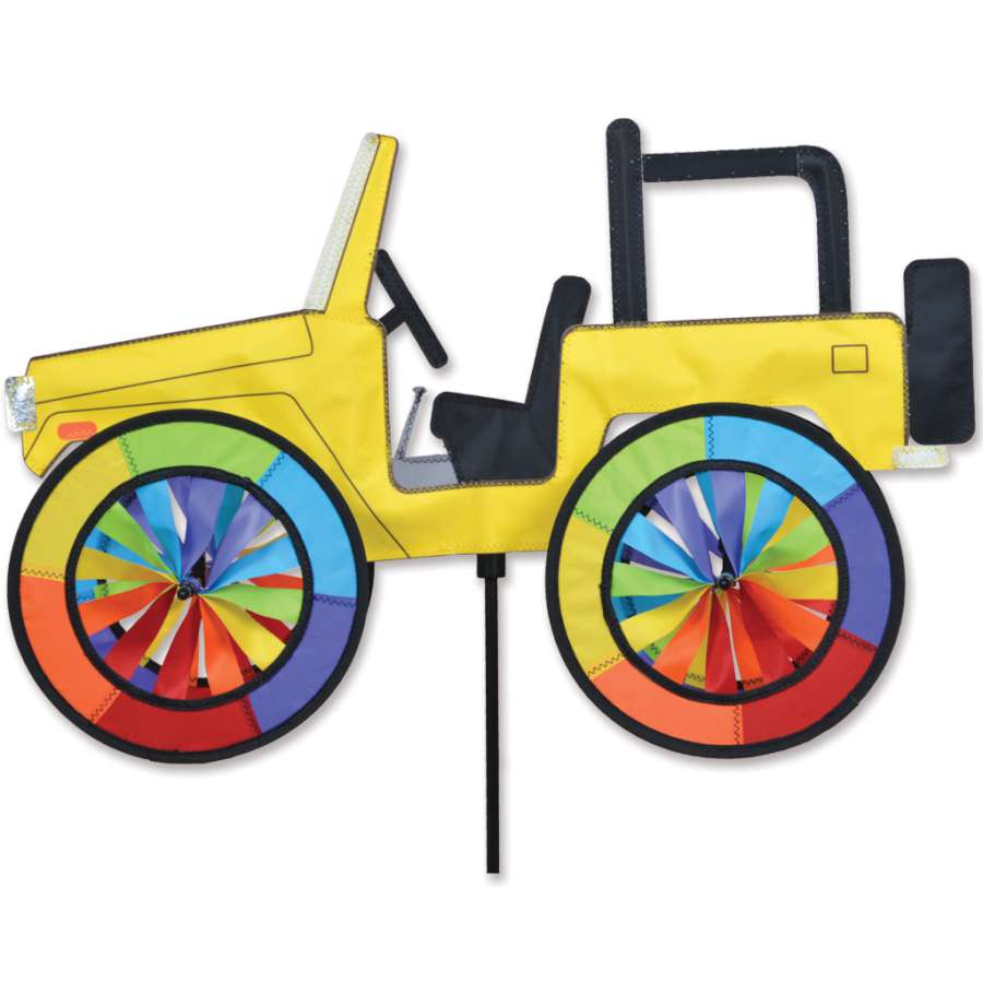 Vibrant 22 in. Yellow Jeep Spinner rotating in an outdoor garden setting, designed for colorful and playful decor.