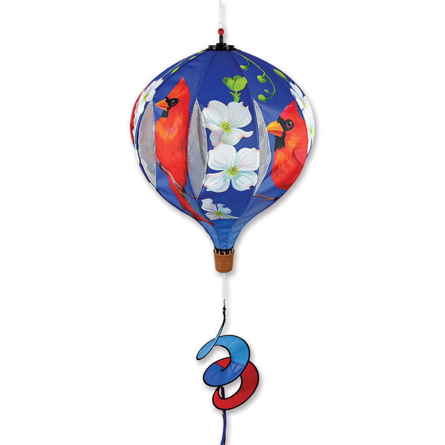 22-inch Pop-Open Hot Air Balloon featuring a cardinal and dogwood blossoms spinning gracefully in the outdoors on a sunny day.