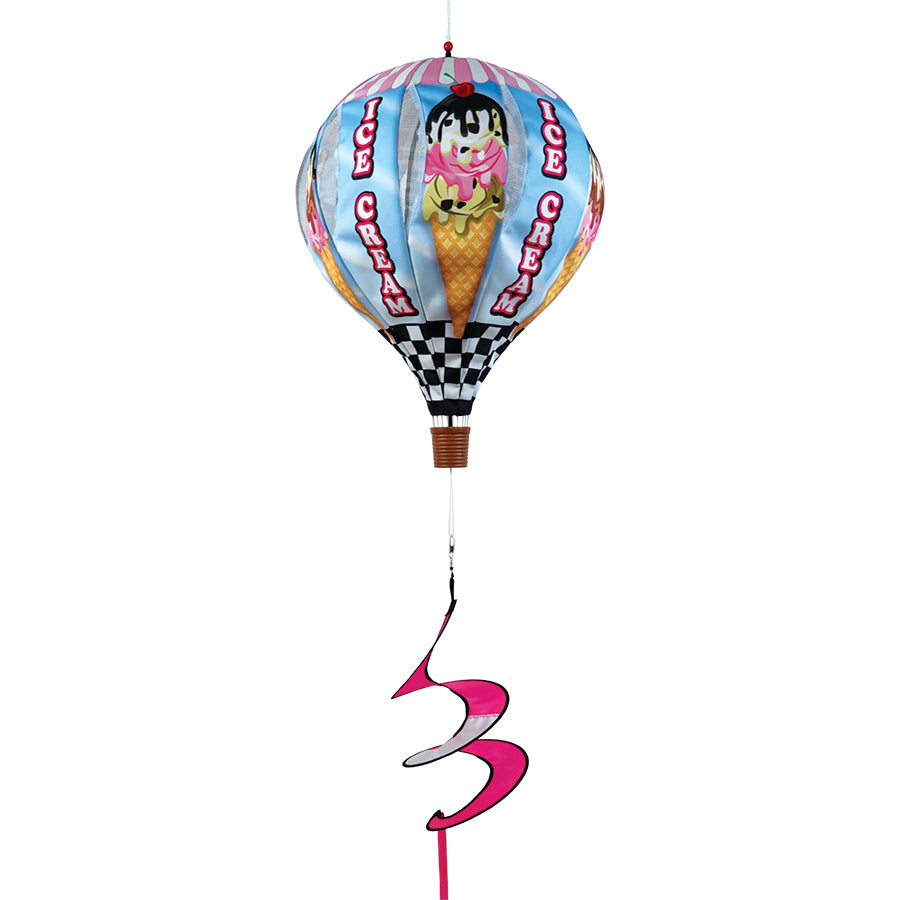 22 in. Pop-Open Hot Air Balloon - Ice Cream displayed on a porch, showcasing its colorful wind spinner design in motion against a clear sky.