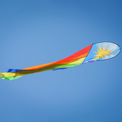 22-inch Sun & Rainbow Dancing Dragon Kite with colorful tails flying against a clear blue sky during a sunny day.