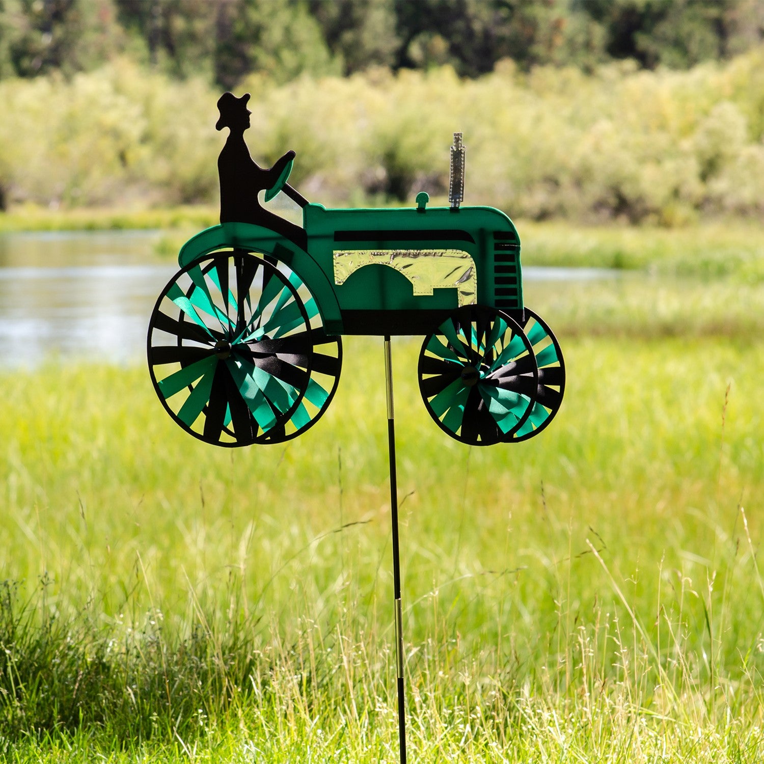 24-inch Green Tractor Spinner with four spinning wheels, vibrant design, and fiberglass frame displayed in a sunny garden setting.
