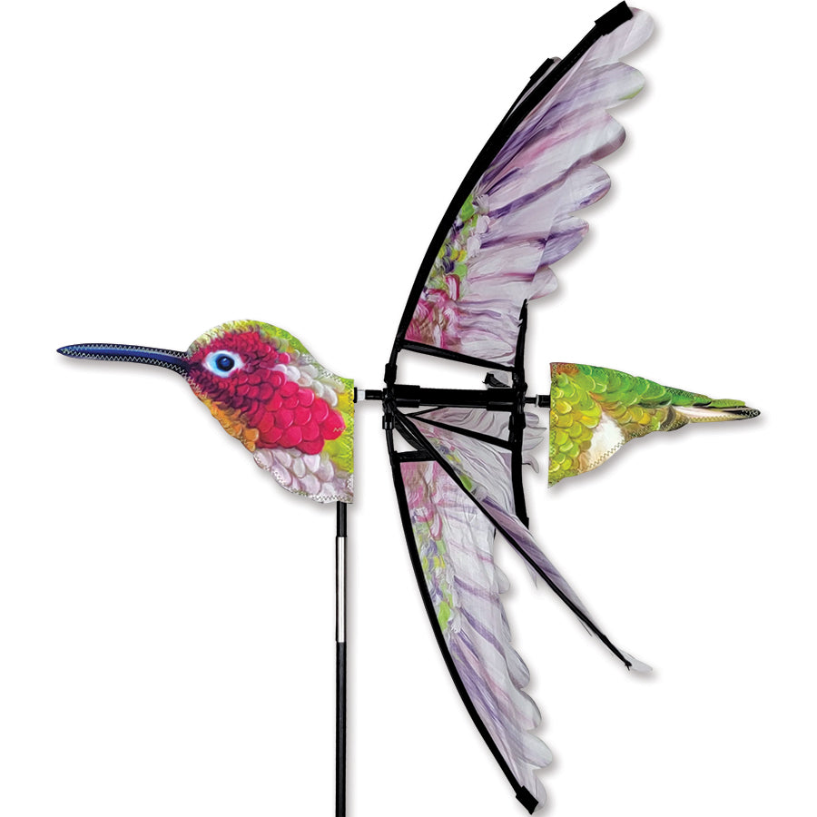 24 in. Anna's Hummingbird Spinner featuring colorful design displayed beautifully in a garden, spinning gracefully in the wind.