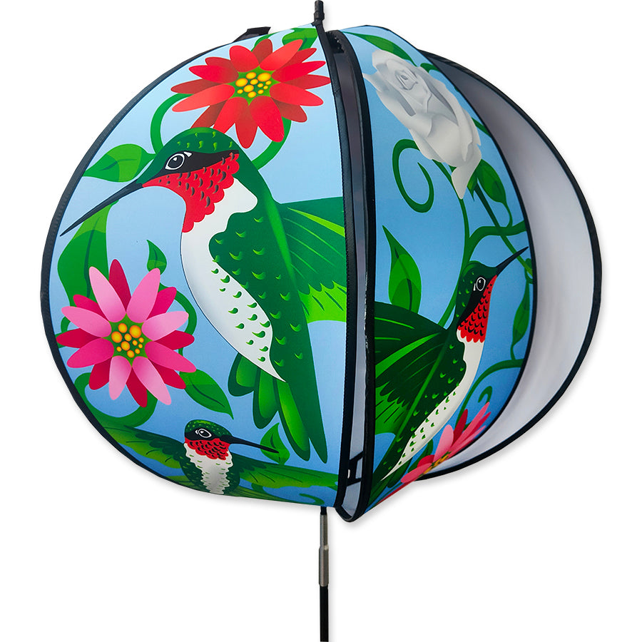 24 in. Ball Spinner featuring colorful hummingbirds and flowers, delicately rotating in a garden setting with vibrant hues.