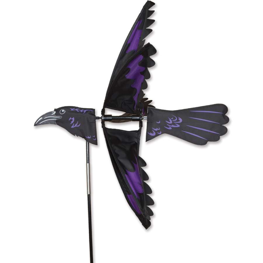 24 in. Raven Spinner featuring intricate raven silhouettes spinning in a gentle breeze outdoors, showcasing vibrant colors.