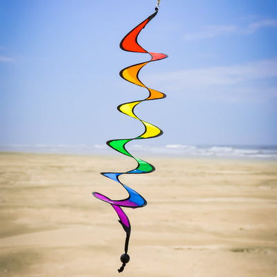 24-inch Rainbow Curlie hanging outdoors, showcasing vibrant colors in swirling patterns, dancing in the breeze with sunny background.