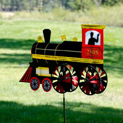24-inch Steam Engine Spinner with vibrant colors and shiny applique accents, spinning gently in a garden setting, evoking retro train nostalgia.