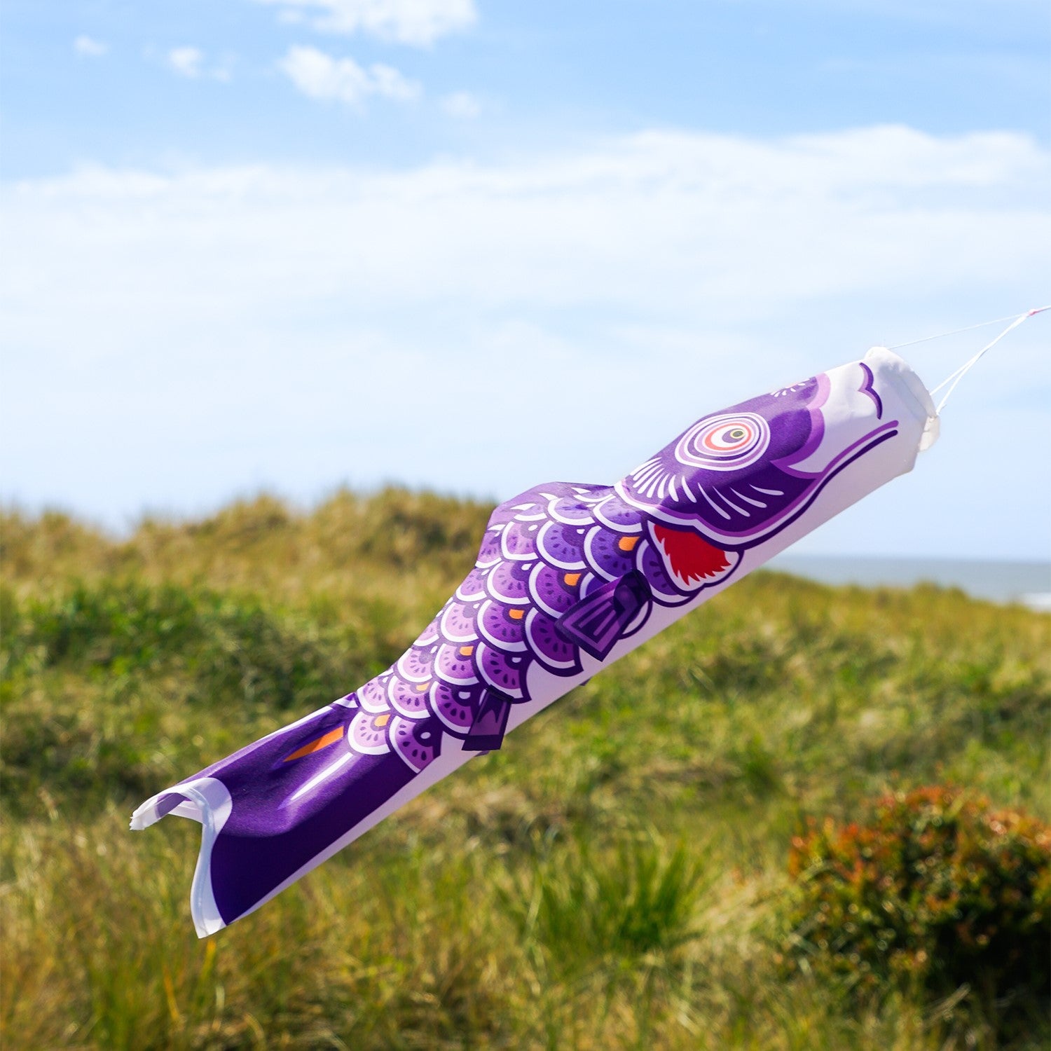 24-inch Purple Koi windsock, beautifully detailed with vibrant colors, swaying gently in the breeze, ideal for outdoor decoration.