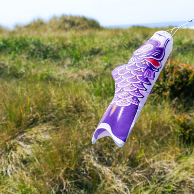 24-inch Purple Koi windsock, beautifully detailed with vibrant colors, swaying gently in the breeze, ideal for outdoor decoration.