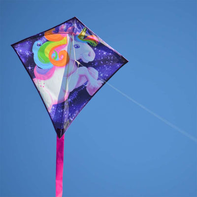 25 in. Diamond Kite - Unicorn with colorful unicorn design, flying in a blue sky, showcasing its vibrant rip-stop polyester fabric.