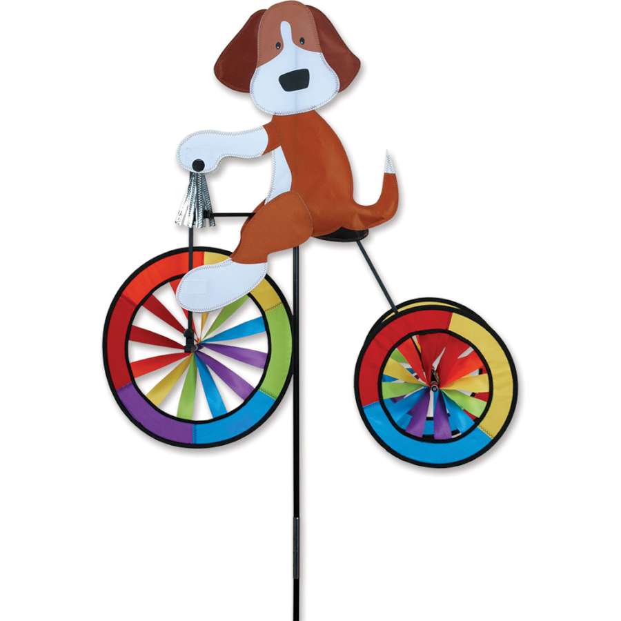 25 in. tricycle spinner with bright colors and silver tassels, spinning playfully in a garden setting, adding a whimsical touch.