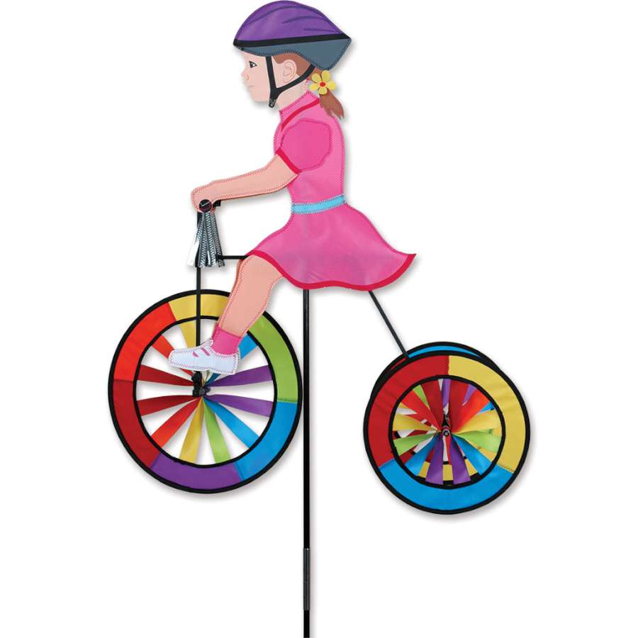 Vibrant 25 in. Tricycle Spinner for kids, featuring colorful design and shiny silver tassels, positioned in a sunny outdoor play area.