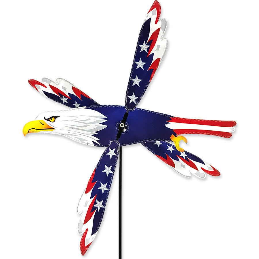 25 in. WhirliGig Spinner showcasing a vibrant Patriotic Eagle design, gracefully spinning outdoors in a garden setting.