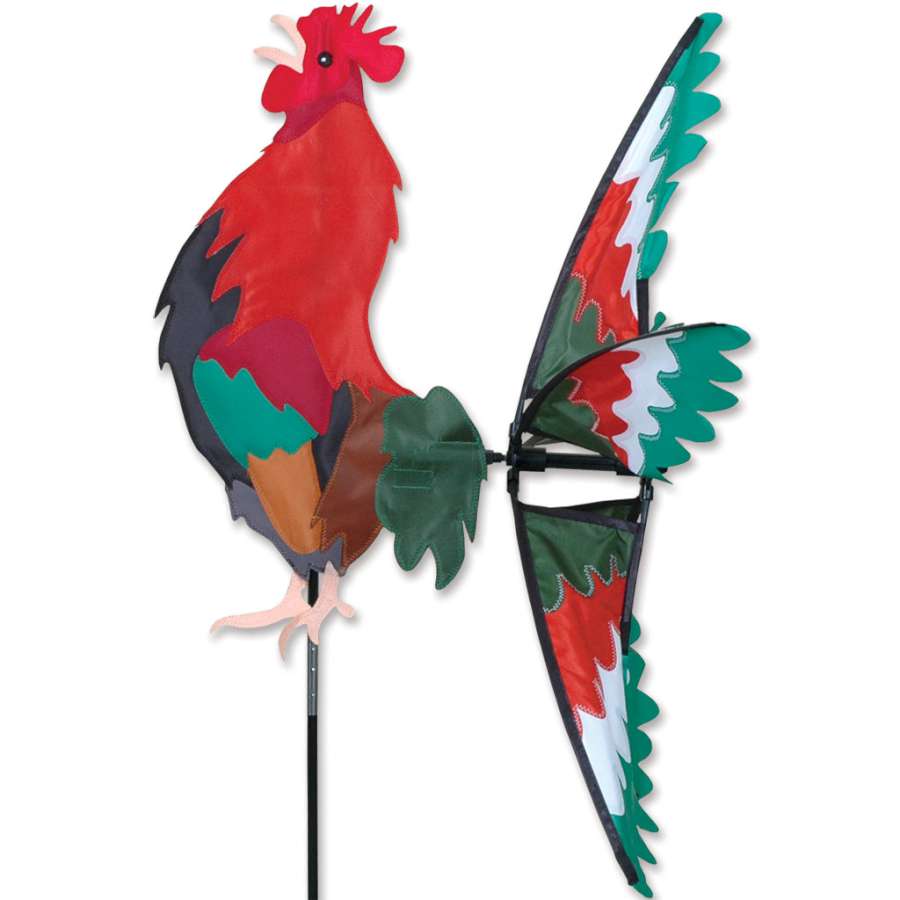26 in. Morning Rooster Spinner, featuring a colorful rooster design, spinning elegantly in an outdoor garden setting under sunlight.