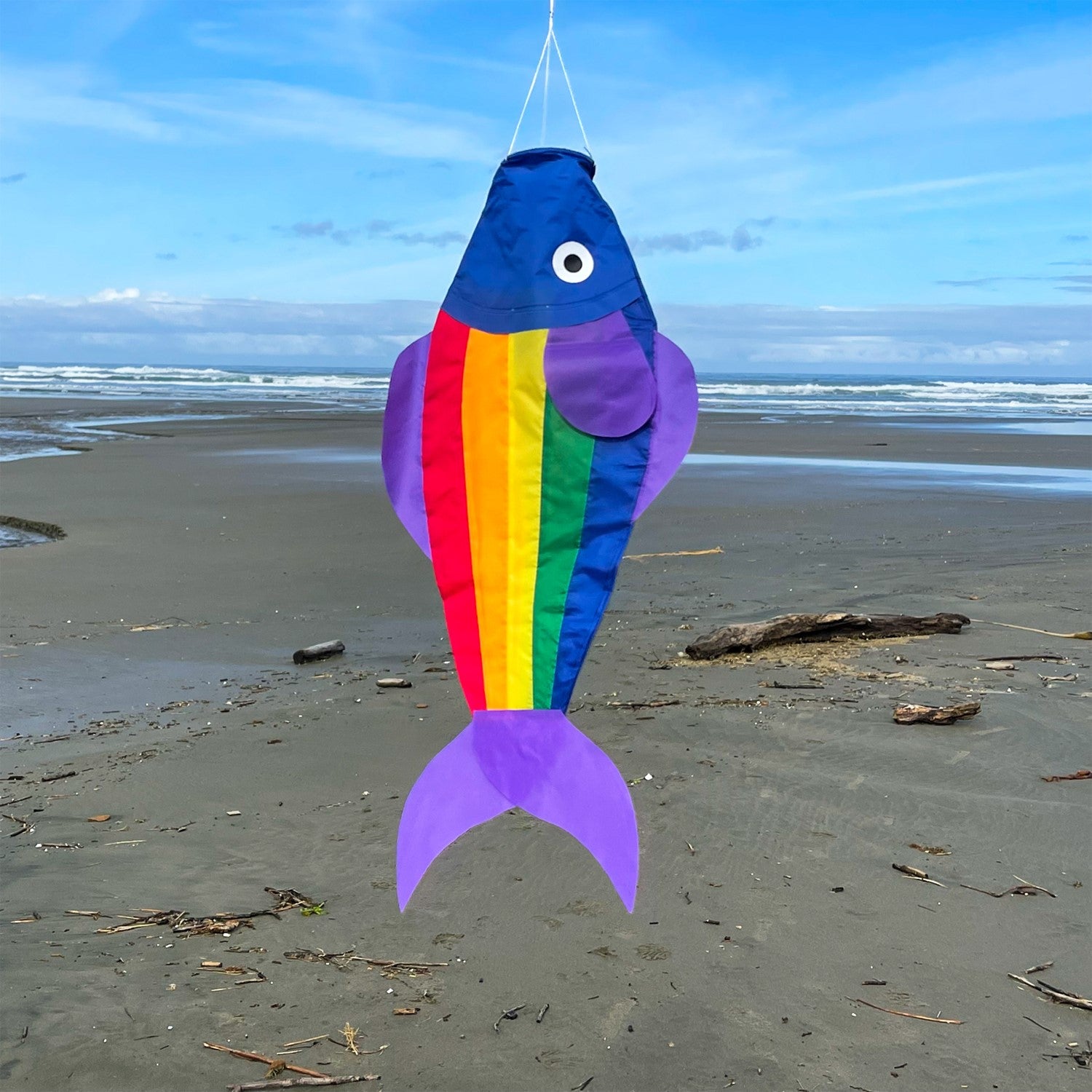 26-inch Rainbow Trout Windsock featuring vibrant rainbow panels, displayed outdoors with a fun 3D effect fluttering in the wind.