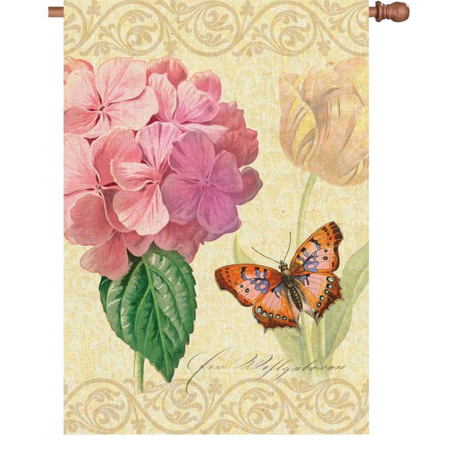 Illuminated 28 in. Botanical Fresh Pink flag featuring vibrant floral design displayed in an outdoor garden setting.