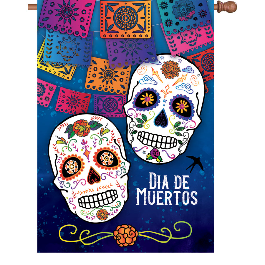 28 in. Dia De Muertos flag featuring colorful skulls and marigolds, displayed outdoors on a flag pole, celebrating the Day of the Dead.