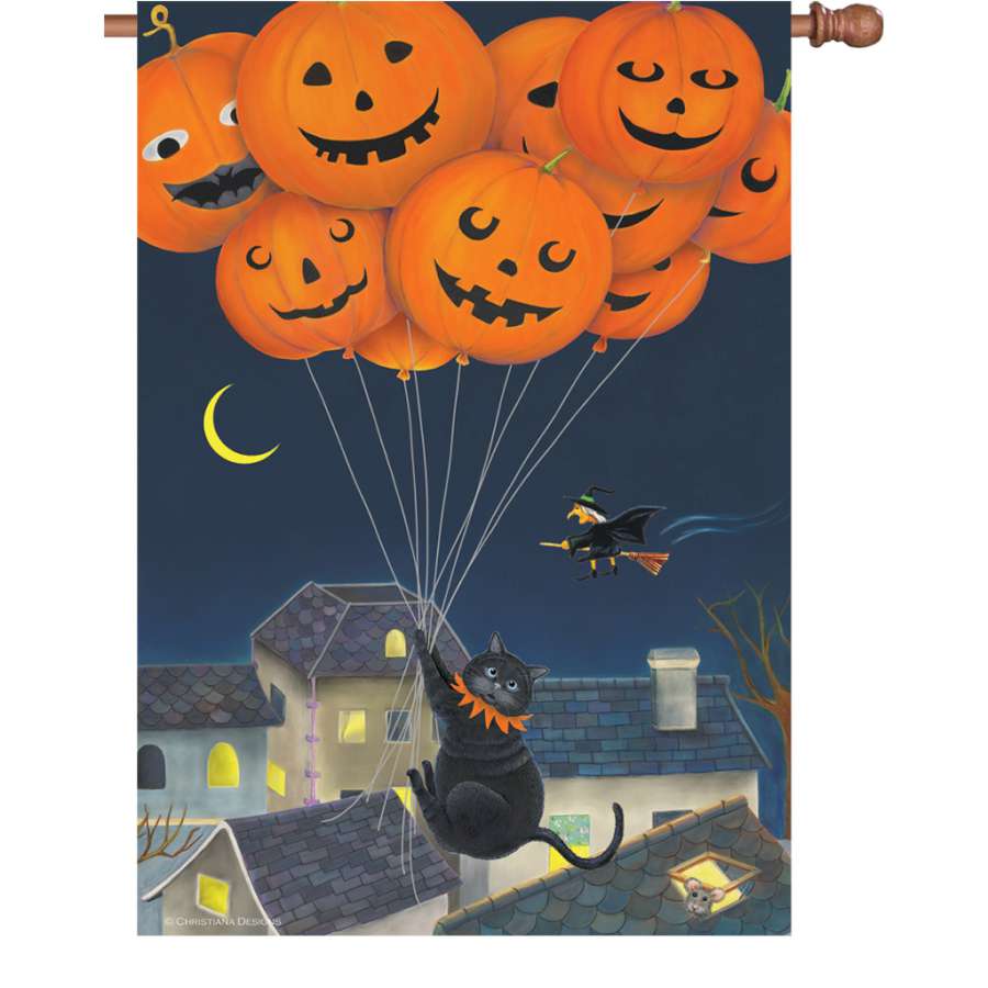 28 in. illuminated flag featuring a playful black cat with colorful balloons, displayed outdoors in a garden setting, adding festive fall charm.