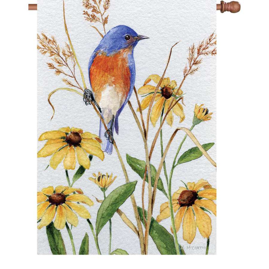 28 in. Flag - Bluebird and Susies displayed outdoors, featuring a colorful bluebird design on durable fabric, illuminating the garden area.