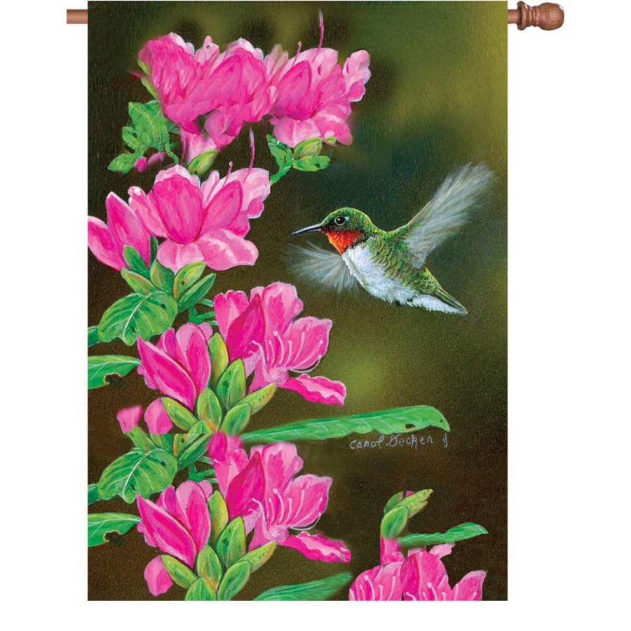 28 in. Flag - Opening Day Hummingbird displayed on a flagpole in a vibrant garden setting, showcasing its colorful design and durability.