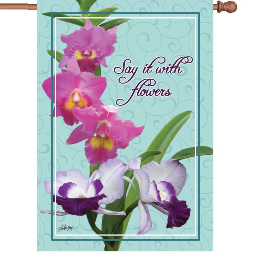 28 in. Say It With Flowers garden flag featuring vibrant floral designs, displayed illuminated in an outdoor garden setting.