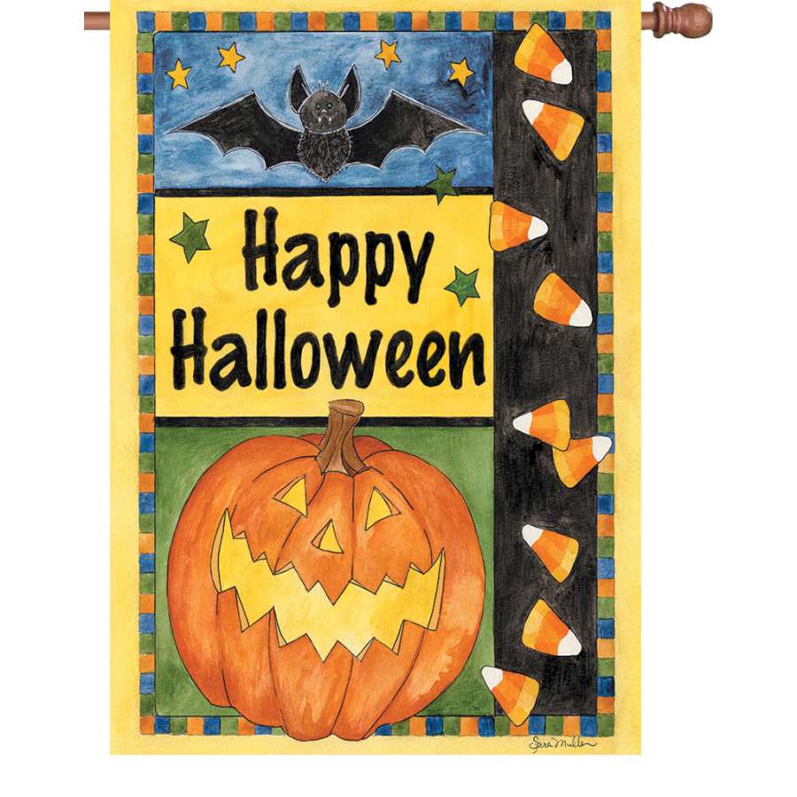 28 in. Halloween Smiles flag featuring bright graphics and the message 'Happy Halloween', displayed in a garden setting with autumn leaves.