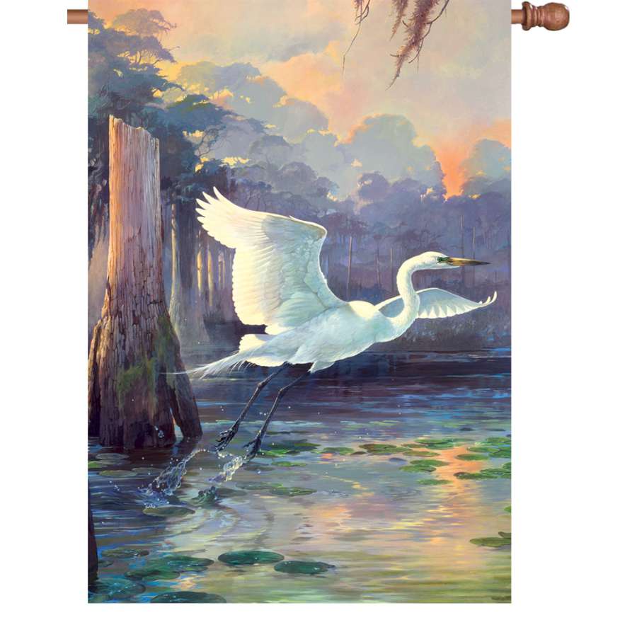 28 in. Heron Sunrise Flag featuring a colorful heron and sunrise design set against a vibrant background, displayed outdoors.