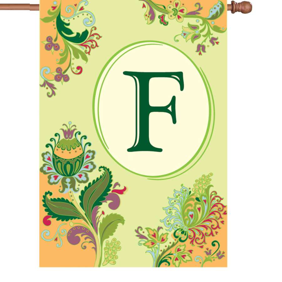 28-inch Spring Monogram Flag - F featuring an elegant letter F design, beautifully displayed on a flagpole in a sunny garden setting.