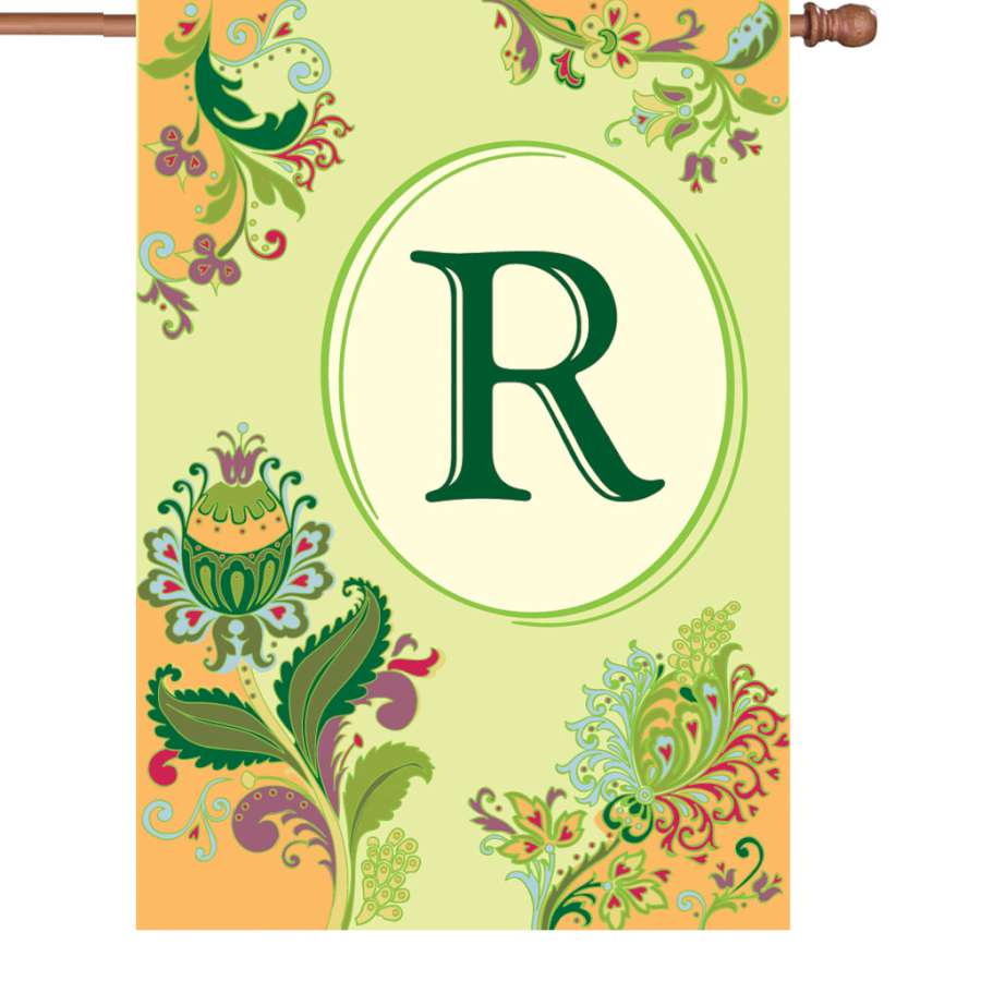 28 in. Spring Monogram Flag featuring the letter 'R' with floral design displayed on an outdoor flagpole in a bright garden setting.