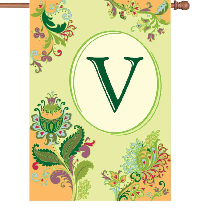 28 in. Spring Monogram Flag - V displayed outdoors in a garden, featuring a vibrant 'V' monogram design that captures the essence of spring.