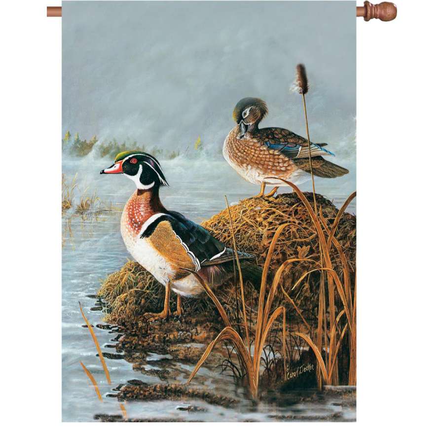 28 in. illuminated Steamy Wood Ducks flag made from fade-resistant polyester, displayed in a garden setting, depicting vibrant and intricate designs.