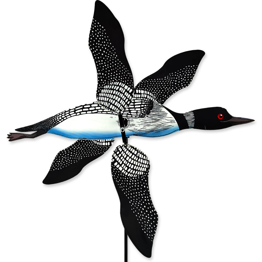 28 inch WhirliGig Spinner - Loon decorated with vibrant colors, spinning in the gentle breeze in a beautifully landscaped garden.