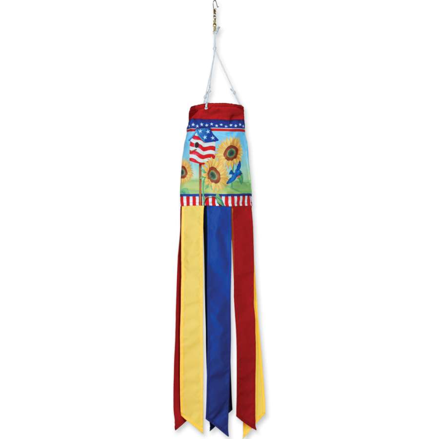 28 in. Windsock featuring bright and colorful patriotic sunflowers, beautifully fluttering in the breeze, displayed outdoors in a garden setting.