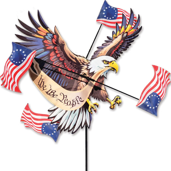 Large patriotic eagle WhirliGig spinner with rotating American flags creates bold motion and Americana-themed outdoor garden décor.