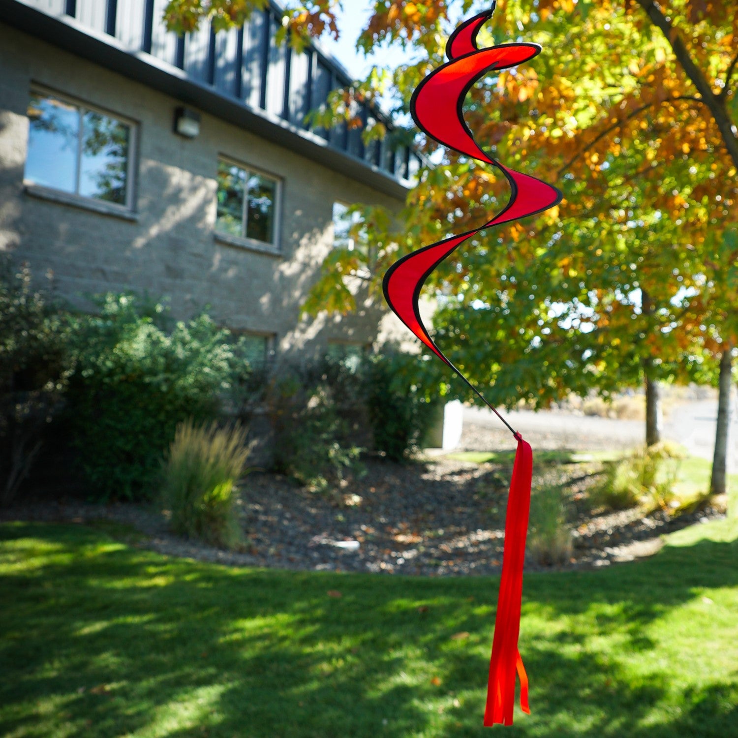 29-inch Red Twister Tail accessory for kites and hot air balloons, elegantly swirling in the outdoor breeze with bright colors.