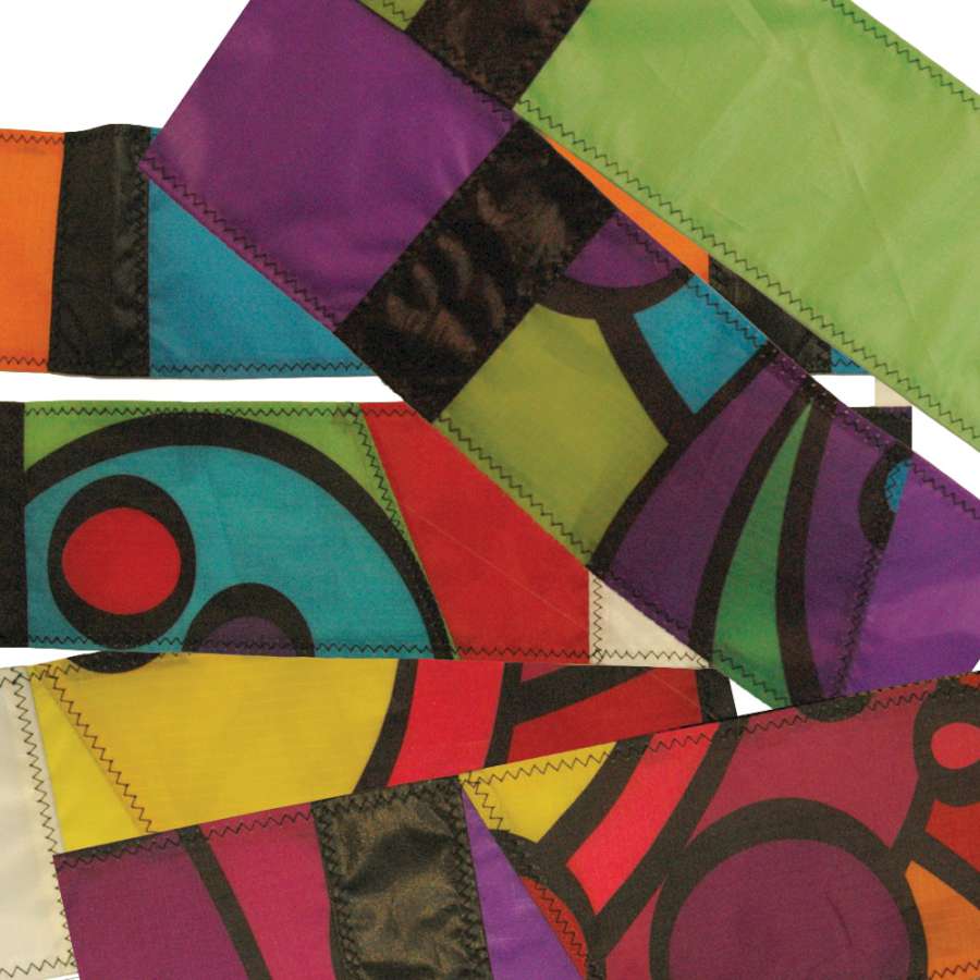 3 in. x 50 ft. Transition Tail - Cool Orbit swirling in the wind, attached to a colorful kite against a clear blue sky.