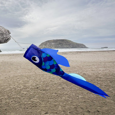30-inch Cool Damsel Fish windsock in vibrant blue colors hanging outdoors, fluttering in the wind with colorful fins moving freely.