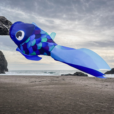 30-inch Cool Damsel Fish windsock in vibrant blue colors hanging outdoors, fluttering in the wind with colorful fins moving freely.
