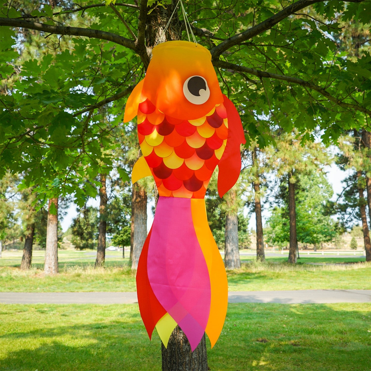 30" Hot Damsel Fish windsock in colorful design, swaying gracefully in the breeze against a sunny outdoor backdrop.
