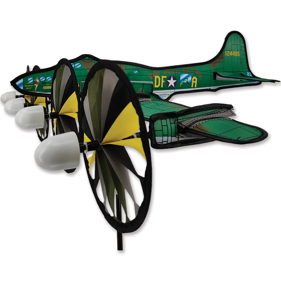 30 in. Airplane Spinner featuring B17 Memphis Belle design, elegantly spinning outdoors among garden flowers in a sunny setting.