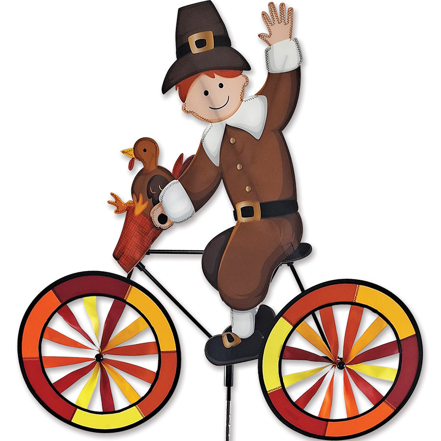 30 in. Bike Spinner features a colorful six-panel design that creates a stunning visual effect while spinning outdoors in a garden setting.