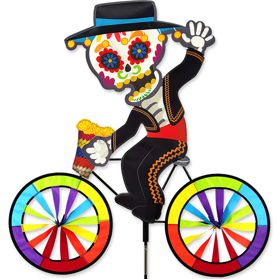 30 in. Bike Spinner featuring Day of the Dead design, displayed on a bicycle, showcasing vibrant colors during outdoor cycling.