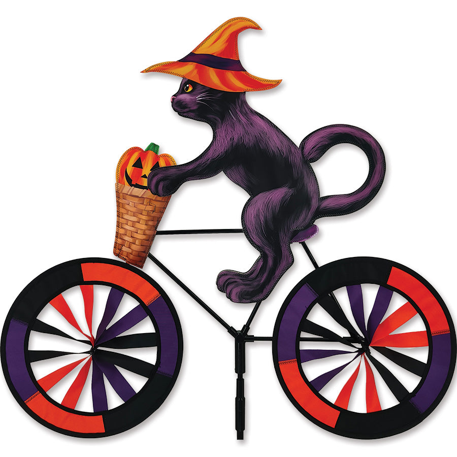 30 in. Bike Spinner featuring a colorful Halloween Cat design, displayed on a bicycle wheel outdoors, creating a festive appearance.