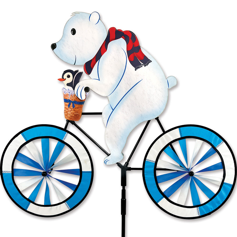 30 in. Bike Spinner featuring a colorful polar bear design, beautifully displayed in a garden setting as it spins in the breeze.